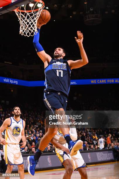 Jeff Withey of the Dallas Mavericks goes to the basket against the Golden State Warriors on December 14, 2017 at ORACLE Arena in Oakland, California....