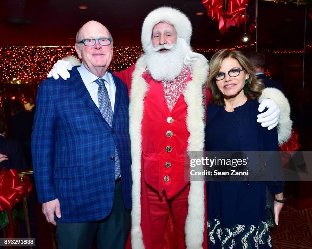 Tom Tuft, Santa Claus and Diane Tuft attend A Christmas Cheer Holiday Party 2017 Hosted by George Farias and Anne and Jay McInerney at The Doubles...