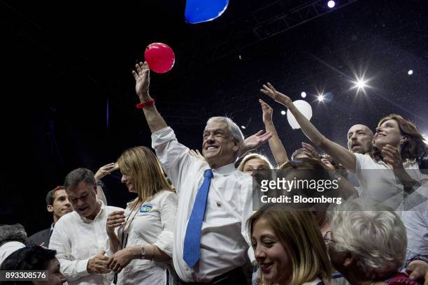Chile's Former President Sebastian Pinera, presidential candidate for the National Renewal party, center, waves while standing with the attendees...
