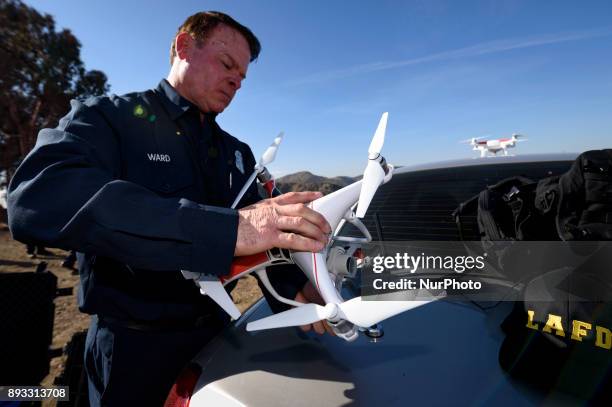 Firefighter and remote drone pilot, Derrick Ward, inspects a drone during a media demonstration by the Los Angeles Fire Department in Los Angeles,...