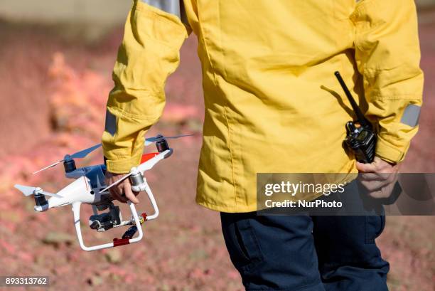 Firefighter holds a drone during a media demonstration by the Los Angeles Fire Department in Los Angeles, California on December 14, 2017. The LAFD...