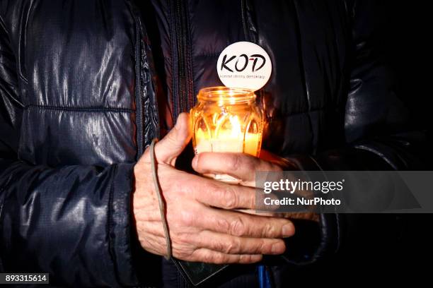 People protest outside the Regional Court during ' Chain of Light ' demonstration against government plans for sweeping changes to Polands judicial...