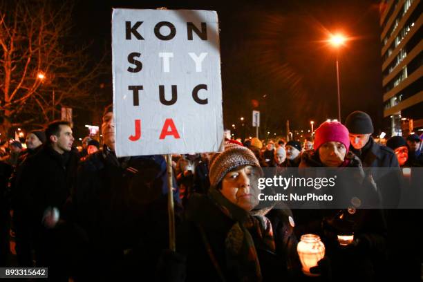 Woman holds 'Constitution' sign during a protest outside the Regional Court during ' Chain of Light ' demonstration against government plans for...