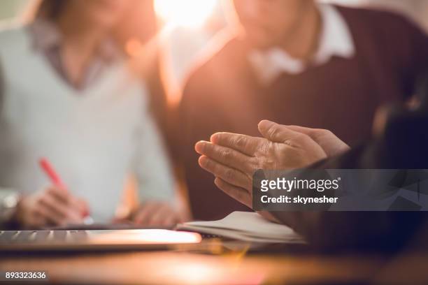 unrecognizable insurance agent rubbing his hands while making a fraud. - social contract stock pictures, royalty-free photos & images