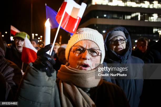 People protest outside the Regional Court during ' Chain of Light ' demonstration against government plans for sweeping changes to Polands judicial...