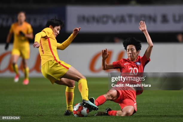 Wang Shanshan of China is tackled by Kim Hyeri of South Korea during the EAFF E-1 Women's Football Championship between South Korea and China at...