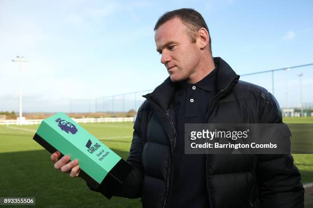 Wayne Rooney of Everton poses with the trophy for Carling Premier League Goal of the Month for November 2017 at USM Finch Farm on December 14, 2017...