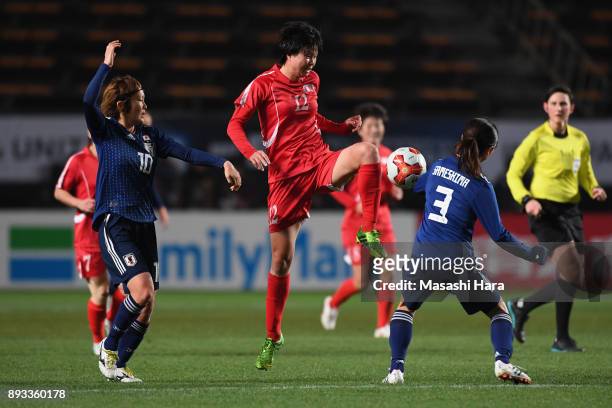 Kim Yun Mi of North Korea controls the ball under pressure of Mizuho Sakaguchi and Aya Sameshima of Japan during the EAFF E-1 Women's Football...