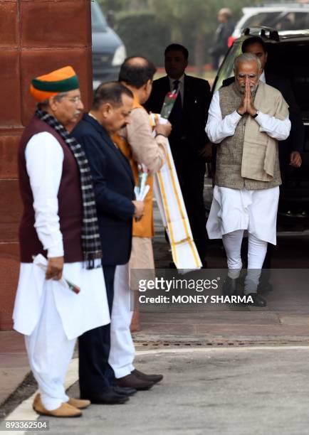 Indian Prime Minister Narendra Modi greets other party leaders as he arrives for the winter session of Parliament in New Delhi on December 15, 2017....