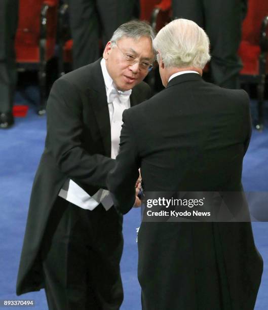 Japan-born British novelist Kazuo Ishiguro receives the 2017 Nobel Prize in literature from Sweden's King Carl XVI Gustaf at a ceremony in Stockholm...