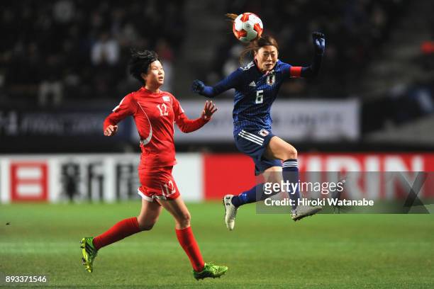 Rumi Utsugi of Japan and Kim Yun Mi of North Korea compete for the ball during the EAFF E-1 Women's Football Championship between Japan and North...