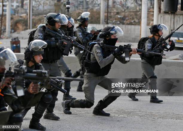 Israeli borderguards take aim as Palestinian protestors gather near the West Bank checkpoint of Qalandia, on the outskirts of Ramallah, on December...