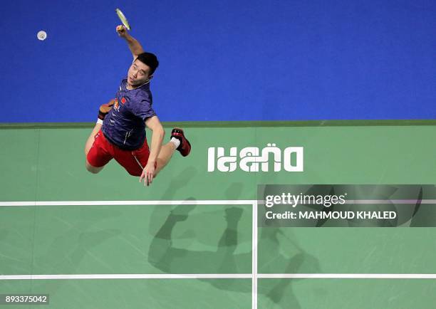 China's Liu Cheng returns the shot to Denmark's Mathias Boe and Carsten Mogensen during the third day of the Dubai Badminton World Superseries Finals...