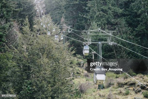 queenstown gondola carries visitors high above queenstown to the skyline complex on bob's peak. - queenstown cable car stock pictures, royalty-free photos & images