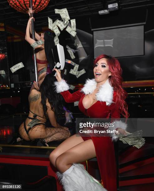 Television personality Farrah Abraham shoots a cash cannon for entertainers during the Crazy Horse III Gentlemen's Club's NEON Flow holiday party on...