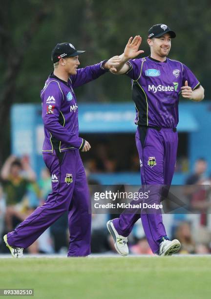George Bailey and D'Arcy Short of the Hurricanes celebrate a wicket during the Twenty20 BBL practice match between the Melbourne Stars and the Hobart...