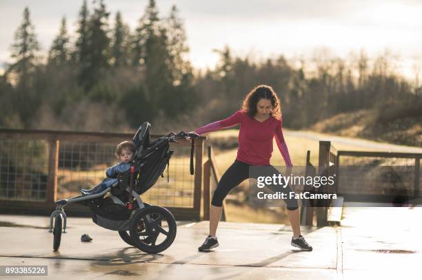 mom goes jogging with infant in stroller - compound bow stock pictures, royalty-free photos & images