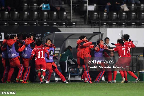 North Korean players celebrate the East Asian Champions following their 2-0 victory in the EAFF E-1 Women's Football Championship between Japan and...