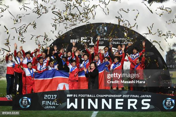 Captain Kim Nam Hui of North Korea lifts the trophy as they cerebrate the East Asian Champions at the award ceremony following their 2-0 victory the...