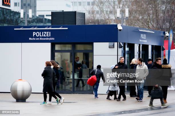 Passers-by pass a new police station at Alexanderplatz on December 15, 2017 in Berlin, Germany. Alexanderplatz, at the heart of Berlin, has seen a...