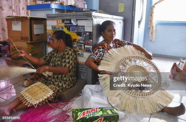 Workers create traditional handicrafts at a shop in Majuro, the Marshall Islands, on Nov. 29, 2017. While the Marshallese had a handicraft tradition...
