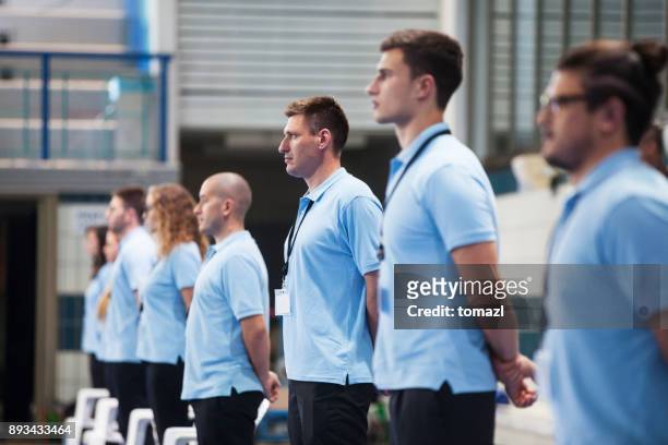 line of judges at a swimming tournament - judge sports official stock pictures, royalty-free photos & images