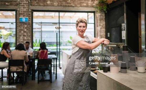 woman with confidence standing in cafe. - restaurant sydney outside stock pictures, royalty-free photos & images