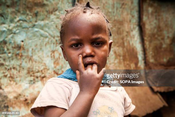 Portrait of a young child at the school's backyard. Ngota's Upendo Primary School is a small school located in the heart of Mathare Slum, Kenya's...