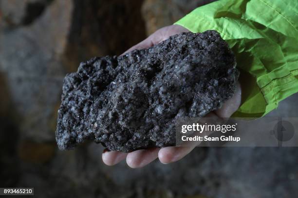 Armin Mueller, CEO of Deutsche Lithium GmbH, holds a rock of Zinnwaldite, a silicate mineral that contains lithium, hewn from a passage in a former...