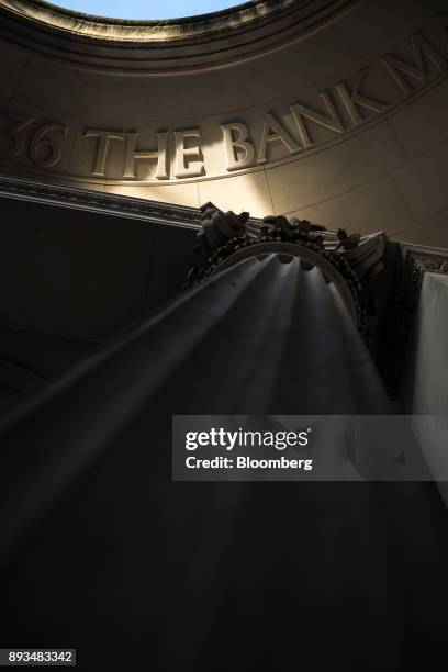 The words "The Bank" sit in masonry lettering on the roof of a public walkway at the Bank of England in the City of London, U.K., on Friday, Dec. 15,...