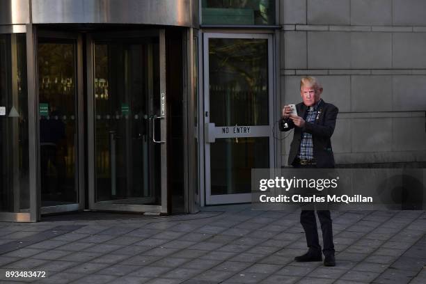 Britain First supporter wears a Donald Trump face mask as Britain First deputy leader Jayda Fransen is released on bail at Belfast Laganside Courts...