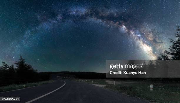 road trip under the milky way - winding road night stock pictures, royalty-free photos & images