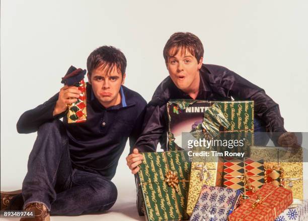 British TV presenters Ant And Dec, Anthony McPartlin and Declan Donnelly, portrait with christmas presents, United Kingdom, 2000.