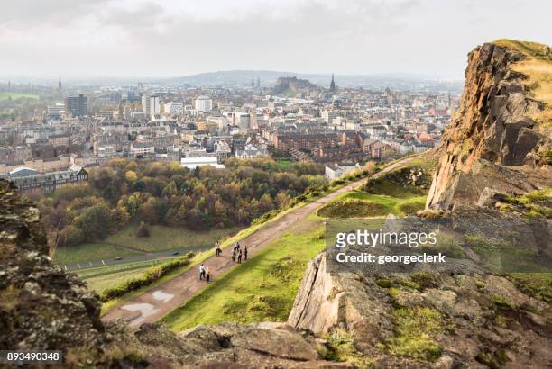 viewing edinburgh from salisbury crags - edinburgh castle people stock pictures, royalty-free photos & images