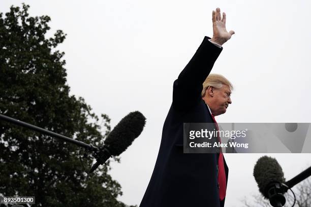 President Donald Trump waves after he spoke to members of the White House Press Corps prior to his Marine One departure from the South Lawn of the...