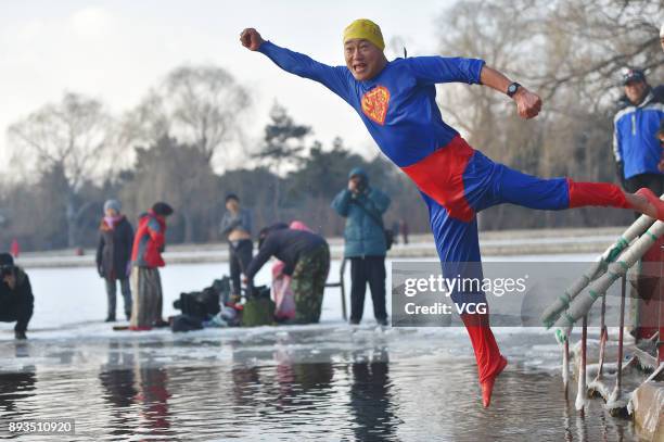 Winter swimming enthusiast dressed like superman jumps into the cold waters of Beiling Park on December 15, 2017 in Shengyang, Liaoning Province of...