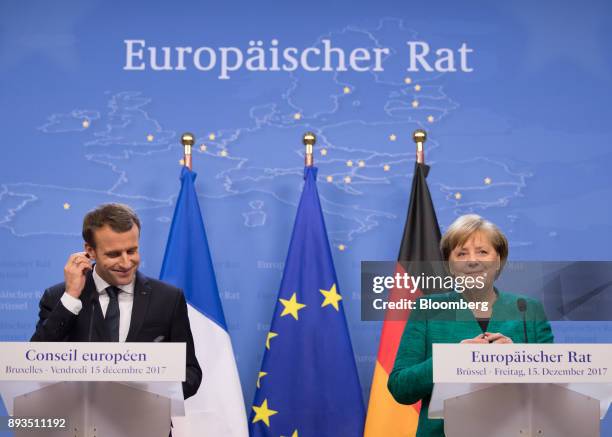 Emmanuel Macron, France's president, left, and Angela Merkel, Germany's chancellor, react during a news conference at a summit of 27 European Union...