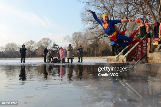 Winter swimming enthusiast dressed like superman jumps into the cold waters of Beiling Park on December 15, 2017 in Shengyang, Liaoning Province of...