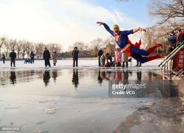 Winter swimming enthusiast dressed like superman jumps into the cold waters of Beiling Park on December 15, 2017 in Shengyang, Liaoning Province of...