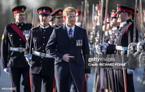 Britain's Prince Harry, representing Britain's Queen Elizabeth II, inspects the graduating officer cadets during the Sovereign's Parade at the Royal...