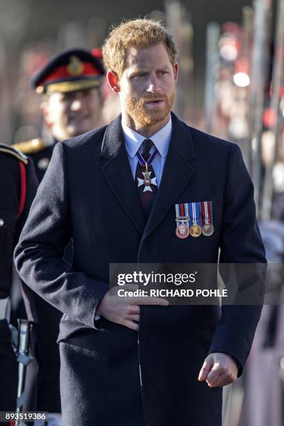 Britain's Prince Harry, representing Britain's Queen Elizabeth II, inspects the graduating officer cadets during the Sovereign's Parade at the Royal...