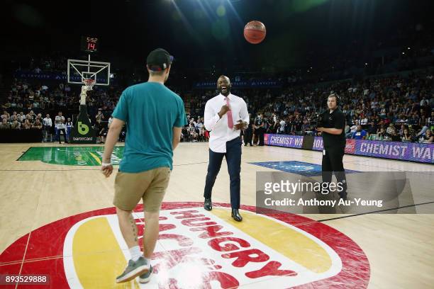 Former NBL MVP and now commentator Corey "Homicide" Williams interacts with the half-court-shot participant during the round 10 NBL match between the...
