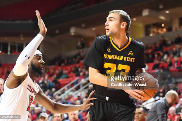 Kosta Jankovic of the Kennesaw State Owls handles the ball against the defense of Niem Stevenson of the Texas Tech Red Raiders during the game on...