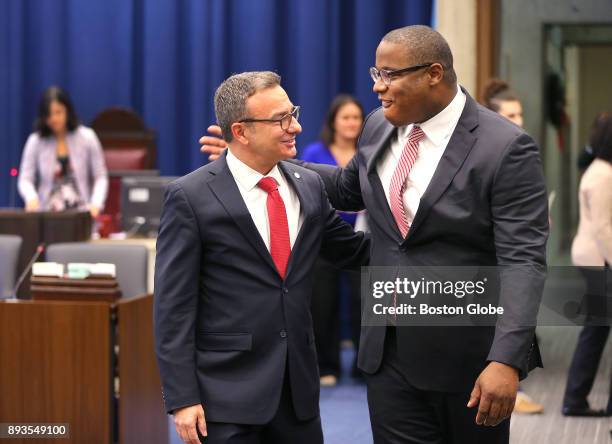 During the last City Council meeting of the year at Boston City Hall, Tito Jackson, right, puts his arm around Sal LaMattina. As they walk to their...