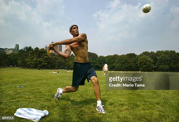 Jason Gravitch plays a game of wiffle ball in Central Park July 2, 2002 in New York City. Temperatures reached into the mid-90's well above the...