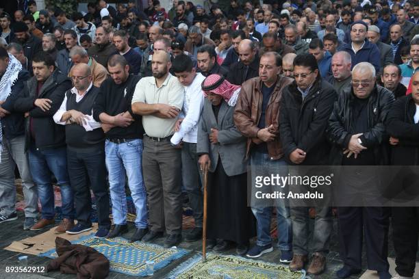 Palestinians perform Friday Prayer as they gather to stage a protest against U.S. President Donald Trumps announcement to recognize Jerusalem as the...