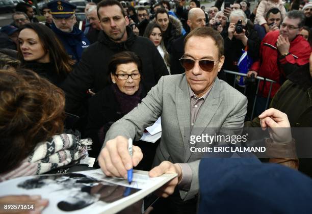 Belgian actor Jean-Claude Van Damme signs autographs to his fans during the European promotion tour of the new Amazon serie "Jean-Claude Van...