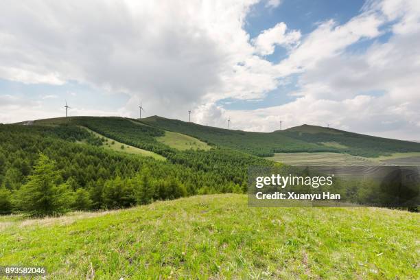 wind turbine on field in hill - grass clearcut stock pictures, royalty-free photos & images