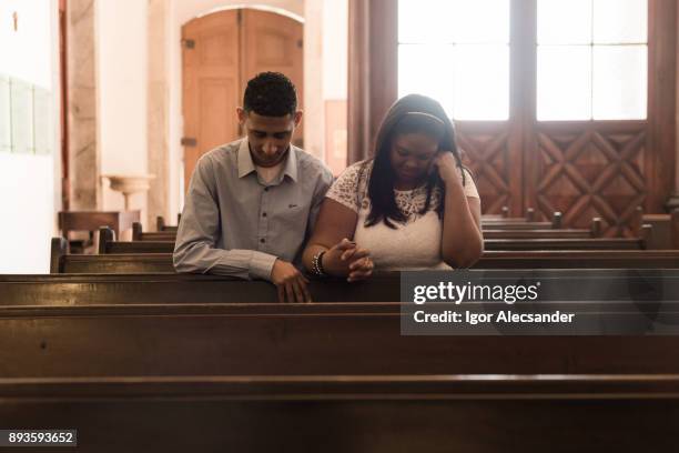 pareja orando - misa fotografías e imágenes de stock