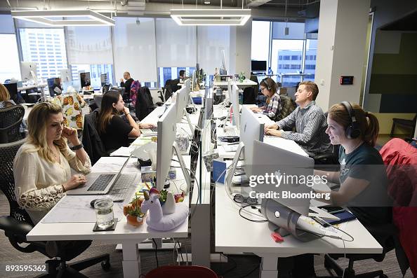 Employees work at the Coinbase Inc. office in San Francisco,... News